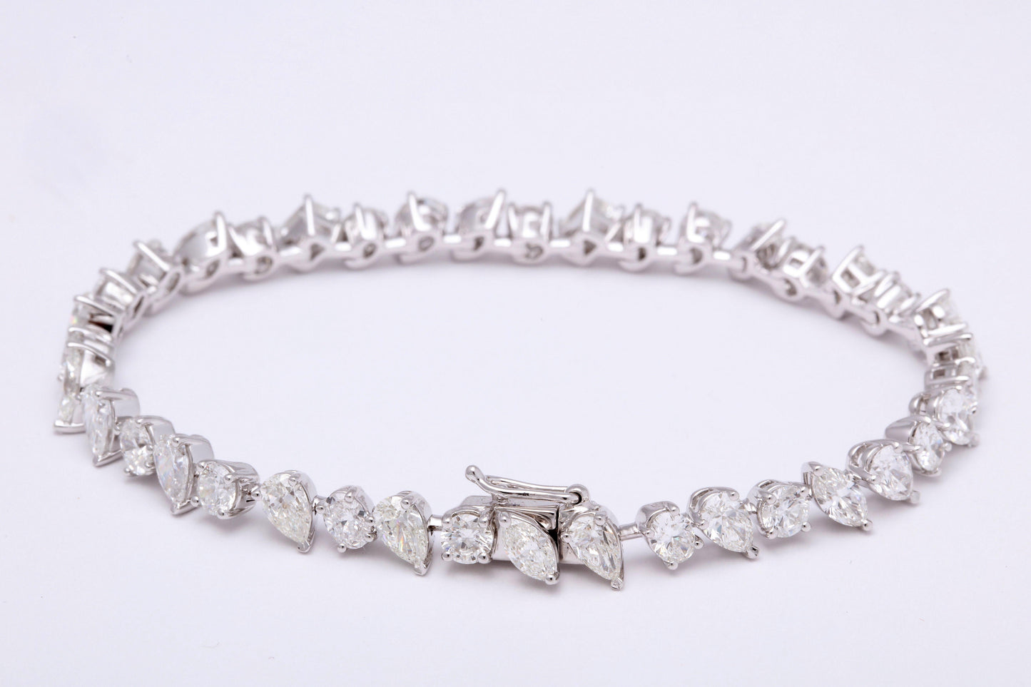 https://a.1stdibscdn.com/multi-shape-diamond-tennis-bracelet-for-sale-picture-2/366869/j_57882221553111184123/1_main_2_org_master.jpg
