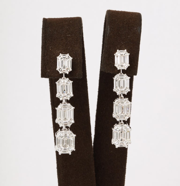 https://a.1stdibscdn.com/emerald-cut-illusion-diamond-dangle-drop-earrings-for-sale-picture-3/j_415/j_164838221658497396818/6R1A9422_master.jpg?width=768